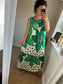 Full length view Women’s green floral maxi dress with oversized flower print and polka dots on ivory background, relaxed fit with gathered neckline