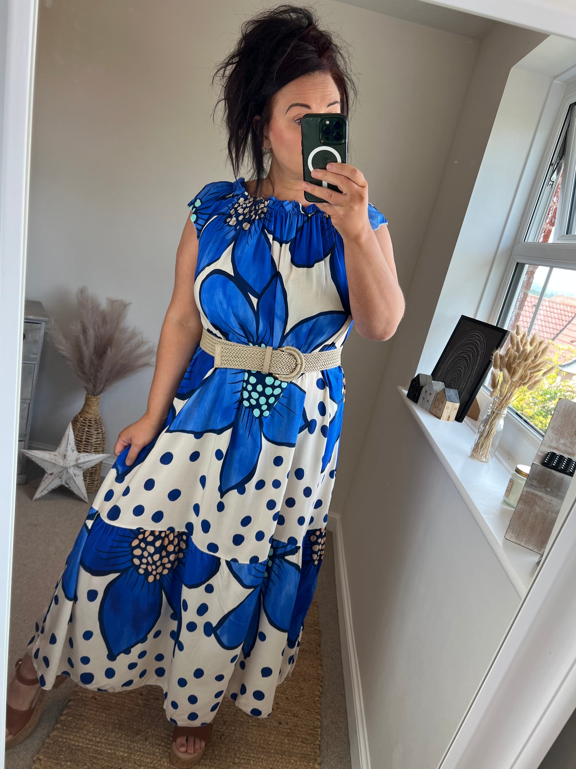 Women’s blue floral maxi dress with oversized flower print and polka dots on ivory background, relaxed fit with gathered neckline, styled with belt