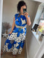 Women’s blue floral maxi dress with oversized flower print and polka dots on ivory background, relaxed fit with gathered neckline, styled with belt