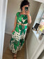 Women’s blue floral maxi dress with oversized flower print and polka dots on ivory background, relaxed fit with gathered neckline, styled with belt